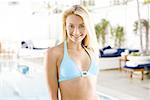 Portrait of a young woman standing at the poolside