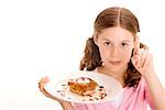Portrait eines Mädchens einen Donut in einen Teller mit Sahne an der Spitze der Finger halten