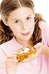 Portrait of a girl holding a donut licking her lips