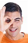 Portrait of a mid adult man making an ok sign in front of his eye