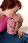 Close-up of a senior woman kissing a senior man