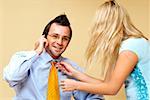 Businesswoman adjusting a businessman's tie