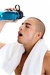 Side profile of a young man pouring water on his face