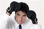 Portrait of a businessman wearing boxing gloves