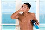 Close-up of a young man holding a bottle of water