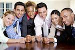 Portrait of a group of business executives with their fists on a table