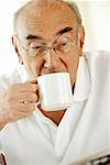 Close-up of a senior man drinking a cup of a coffee