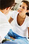 Close-up of a young man feeding a young woman cherries