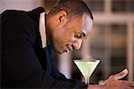 Side profile of a businessman with a glass of martini