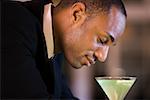 Side profile of a businessman with a glass of martini