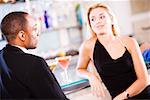 Young couple sitting at a bar counter