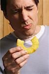 Man Eating Pineapple Slice