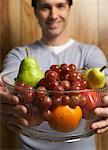 Man Holding Bowl of Fruit