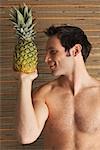 Man Holding Pineapple