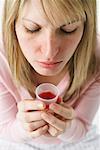 Woman Holding Cough Syrup