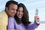 Couple Taking Picture With Cell Phone At The Beach