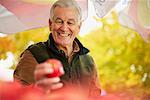 Man Looking at Apple