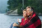 Couple Sitting Beside Lake