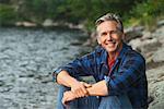 Man Sitting Beside Lake