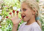 Girl Wearing Raspberries On Her Fingers