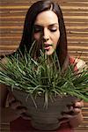 Portrait of Woman Holding Plant