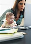 Mother and Baby Looking at Laptop Computer