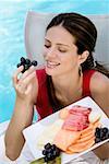 Close-up of a young woman eating fruits