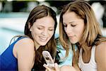 Close-up of two young women looking at a mobile phone