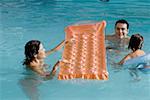 High angle view of parents with their daughter in a swimming pool