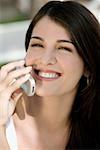 Close-up of a young woman talking on a mobile phone