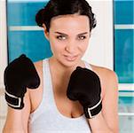 Portrait of a young woman practicing boxing