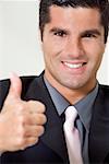 Portrait of a businessman showing thumbs up