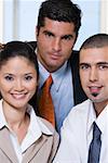 Portrait of two businessmen and a businesswoman in an office