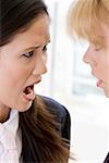 Close-up of a businesswoman scolding another businesswoman