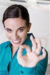 Portrait of a businesswoman making an ok sign