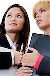 Low angle view of two businesswomen holding a laptop and a file