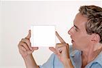 Close-up of a mid adult man holding a CD case