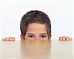 Boy Peeking over Wooden Table