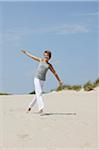 Woman Running over Sand