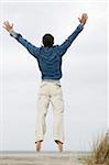 Man Jumping on Beach