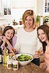 Mother Preparing Salad with Daughters
