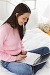 Woman on Bed with Laptop