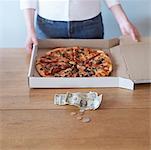 Woman With Pizza and Change on Table