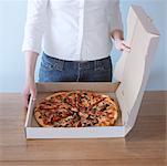 Woman Opening Pizza Box