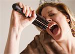 Woman Dressed Up, Singing Into Hair Brush