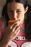 Woman Eating an Orange