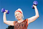 Senior adult woman lifting dumbbells