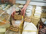 Woman reaching into delicatessen display