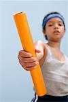 Boy passing relay baton