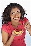 Portrait of Woman Eating Grapefruit